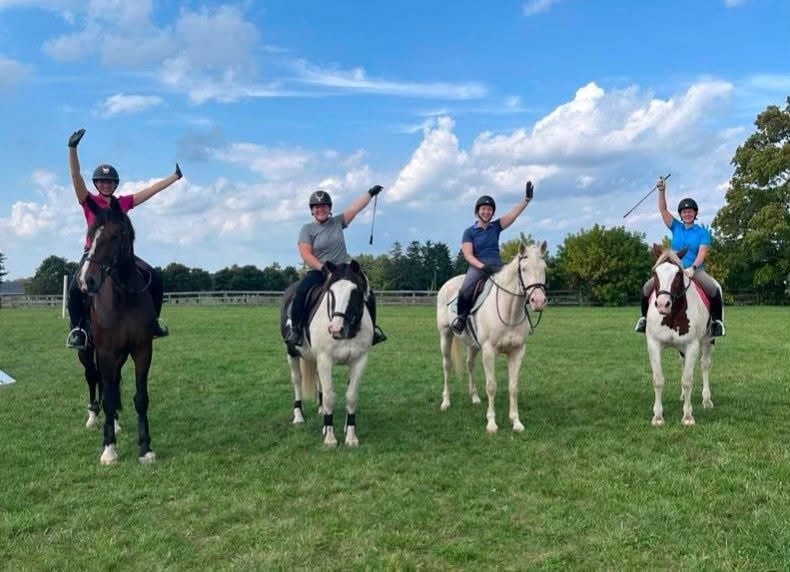Riders celebrating after a lesson at Twisted Equine